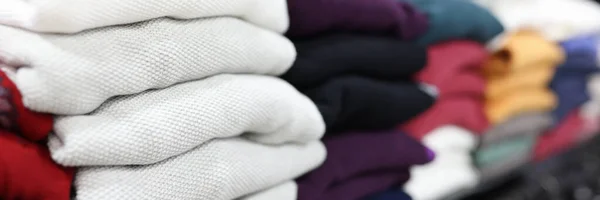 Folded clothes lying on store shelf closeup — Stock Photo, Image