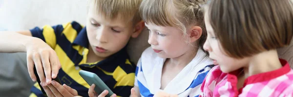 Meisjes en jongen op de bank — Stockfoto