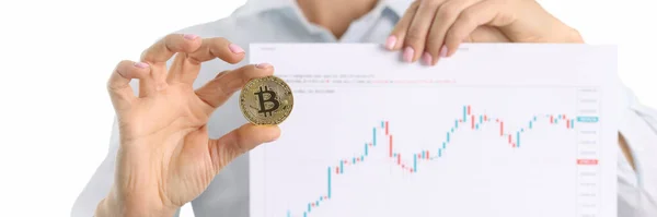 Cryptocurrency consultant holds bitcoin and graph with financial indicators in hands — Stock Photo, Image