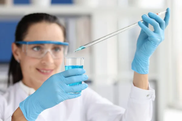 푸른 액체 시험관을 가지고 실험실에서 일하는 연구가 들 — 스톡 사진