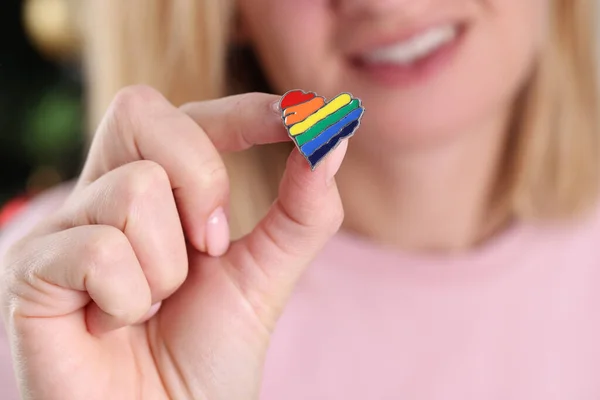 Smiling woman holding small lgbt icon closeup — стоковое фото