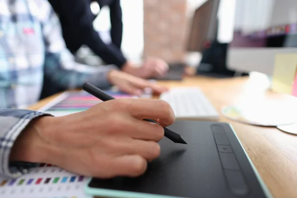 Woman graphic designer graphics tablet at table closeup