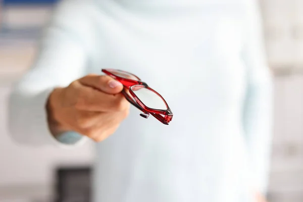 Beautiful stylish glasses in woman hand closeup — Stock Photo, Image