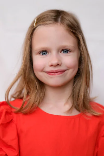 Portrait of beautiful smiling little girl in red dress —  Fotos de Stock
