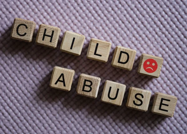 Text child abuse and angry smiley closeup — Foto Stock