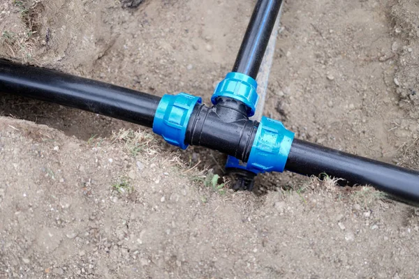 Installed PVC water pipes are assembled and laid in trench at construction site — Foto Stock