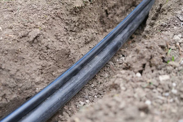 Black pvc sewer pipe Optical fiber communication and communication infrastructure — Stok fotoğraf