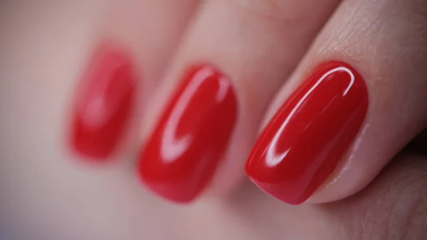 Female hand with red bright glossy varnish — Stock Photo, Image