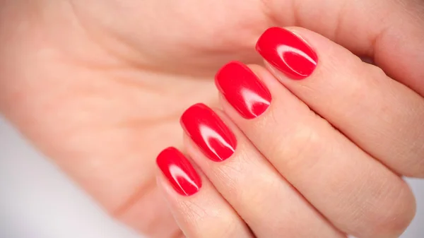 Mains féminines avec de beaux ongles rouge vif gros plan — Photo