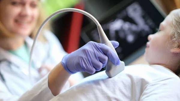 Close-up of diagnostic examination of internal organs in children using ultrasound machine. Ultrasound scanner of abdominal cavity procedure