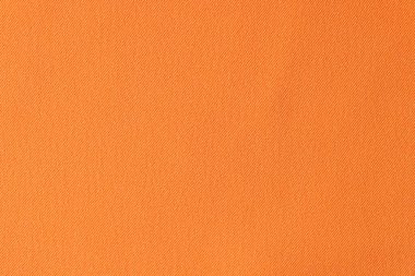 Portakallı pamuğun üst görüntüsü pürüzsüz kumaş dokusu arka planı. Tasarım çalışmaları için parlak turuncu bez arkaplan