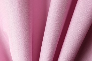 Arka plan ve tasarım çalışmaları için pembe kumaş dokusu üst görünümü. Katlama yüzey arka planında pembe tekstil