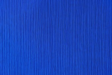 Koyu mavi, buruşuk ve buruşuk kumaş dokusunun üst görüntüsü. Kusursuz desenli kumaş soyut arkaplan