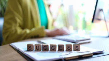 Close-up of success word collected with wooden cubes in row. Goal achievement, targeting, and business concept
