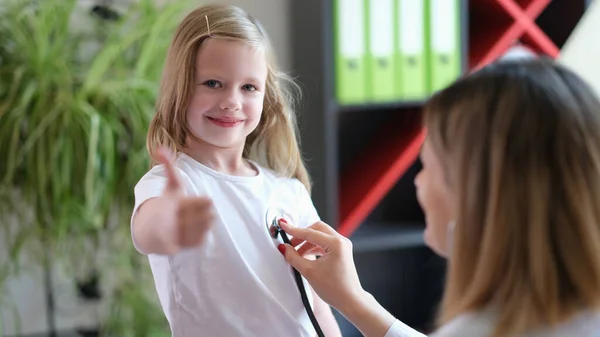 Portrait Little Girl Doctor Appointment Clinic Office Showing Thumb Sign — Stockfoto