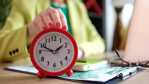 Close Woman Putting Red Alarm Clock Desk Time Management Deadline — Zdjęcie stockowe