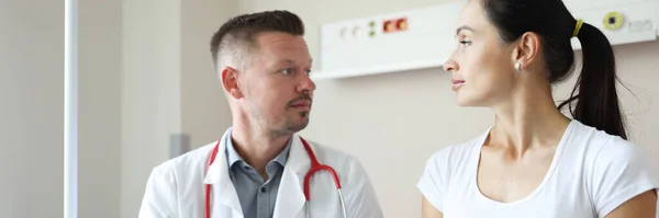 Male Doctor Communicates Female Patient Clinic Medical Care Examination Concept — стоковое фото