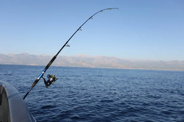 Sea fishing from steel fishing boat on open water. Sunny day at sea and fishing