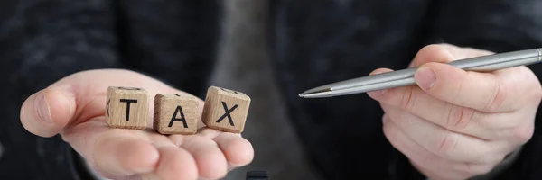 Inscription Tax Cubes Businessman Holds Pen Tax Deductions State Concept — Foto de Stock