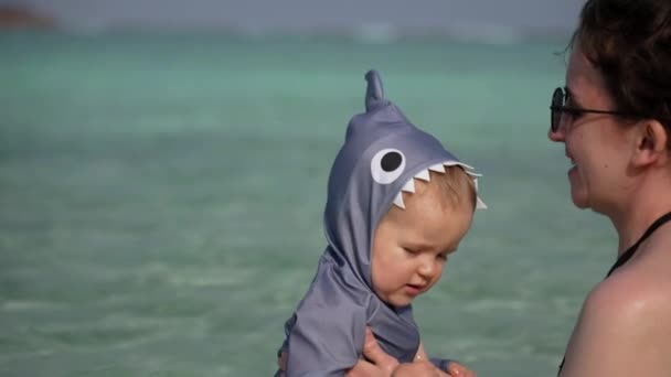 Mother Raises Lowers Child Shark Suit Ocean Back Bathing Swimming — 图库视频影像