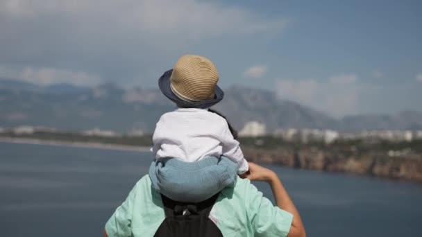 Mom Carries Son Hat Shoulders Looking Sea Forestry Mountains Woman — Stok video