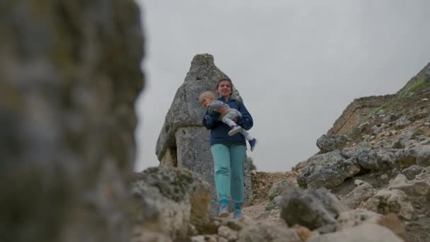 Mother Carries Son Walking Big Stones Rocky Area Cloudy Sky — Wideo stockowe