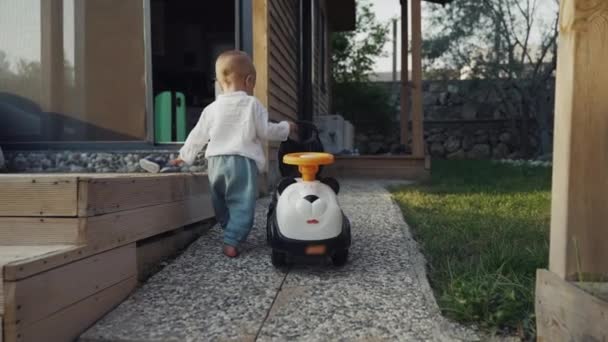 Blond Toddler Walks Pavement Carrying Children Scooter Yard Country House — Wideo stockowe