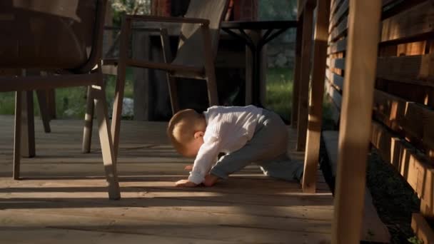 Toddler Exercises Chairs Wooden Boards Floor Garden Gazebo Sunset Little — Vídeos de Stock