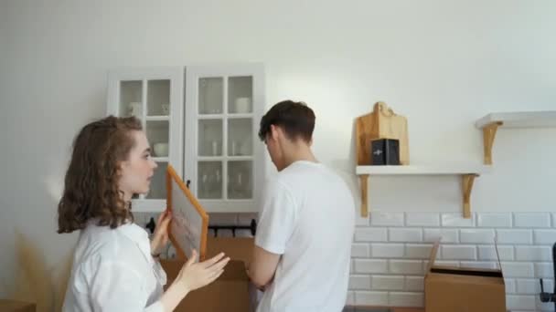 Young Couple Unpacks Things Out Paper Boxes Moving New Apartment — Vídeos de Stock