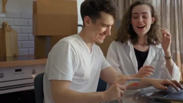 Happy Couple Makes Online Purchases Website Notebook Sitting Kitchen Table — Stock video