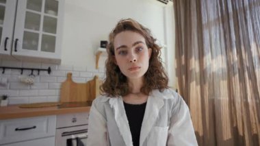 POV of irritated woman arguing with boyfriend on video call. Young lady sits at kitchen table at home talking at camera and discussing closeup