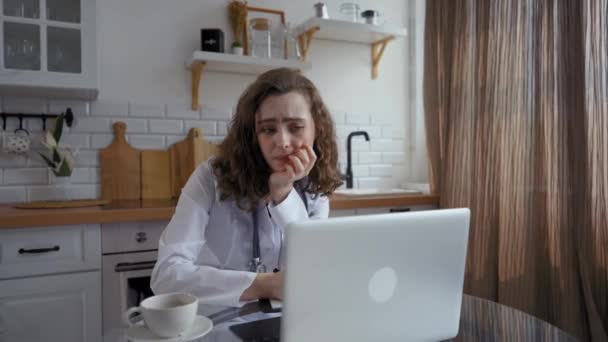 Female Doctor Listens Boring Online Lecture Laptop Holding Pen Hand — Stockvideo