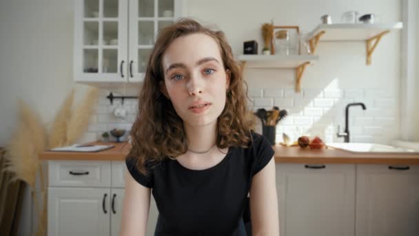 Young Woman Talks Looking Camera Drinking Tea Countertop Kitchen Lady — Vídeos de Stock