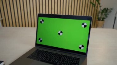 Employee talks on video call with manager via modern laptop. Electronic device with chromakey screen stands on desk in office closeup place to insert