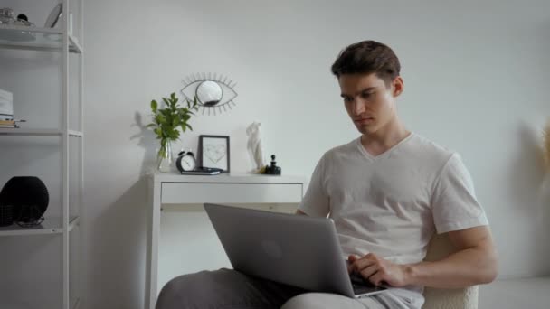 Young Man Sits Chair White Wall Working Laptop Stylish Room — Stock videók