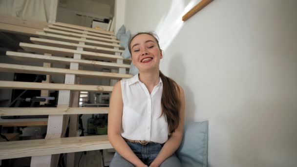 Woman Enjoys Talking Video Call Sitting Wooden Stairs Big House — Vídeo de stock