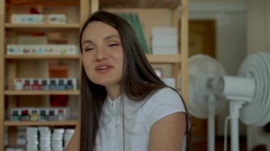 Young women communicate with mentor at business meeting. Diligent ladies answer questions sitting at desks in audience closeup slow motion
