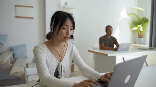Young Asian Woman Headset Works Customer Support Advising Client Lady — Stockvideo