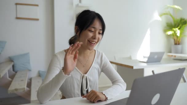 Cheerful Asian Woman Waves Hello Video Call Friend Modern Laptop — 비디오