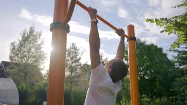 Mature Man Tries Catch Yellow Crossbar Jumping Back Lit Middle — Vídeo de Stock