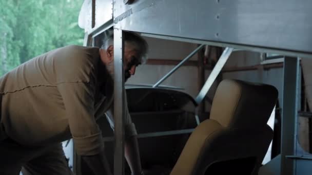 Senior Bearded Craftsman Checks Quality Aircraft Pilot Seat Aged Engineer — Vídeo de Stock