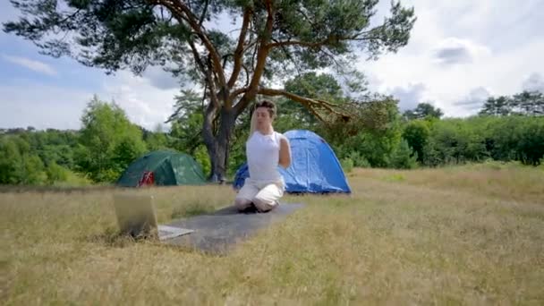 Young Man Does Yoga Mat Tent Trees Black Haired Hiker — Stockvideo