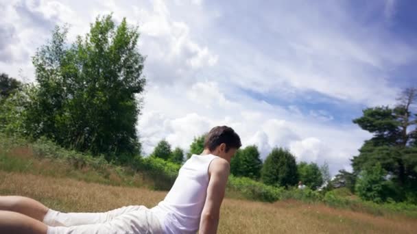 Young Man Practices Yoga Mat Put Forest Meadow Grass Black — Vídeos de Stock
