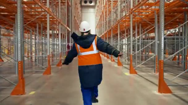 Happy Female Engineer Runs Jumps Aisle Empty Metal Racks Cold — Stok video