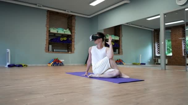 Man Virtual Reality Goggles Sits Yoga Half Spinal Twist Pose — Wideo stockowe