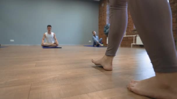 Woman Unrolls Blue Mat Wooden Floor Yoga Training Sports Club — Stok video
