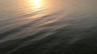 The surface of the water is illuminated by sunlight. Dawn.