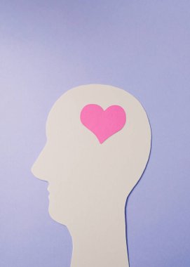 Silhouettes on a violet background with pink heart. Minimalist concept of love. Valentine's day.