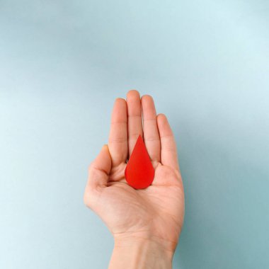 A red drop of blood on the palm