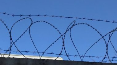 Hapishane duvarındaki dikenli teller yağmurun altında. Ağır çekim. Kaydırma 